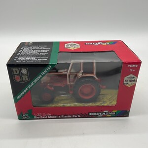 May include: A boxed 1:32 scale die-cast model of a weathered David Brown tractor. The toy tractor is red and white, with black tires, and is displayed in a red and black box with the Britains logo.