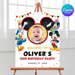 May include: A colorful birthday party sign featuring Mickey Mouse, Minnie Mouse, and Donald Duck. The sign includes a photo of a baby and the text "Welcome to Oliver's 2nd Birthday Party" with the date January 27, 2025.