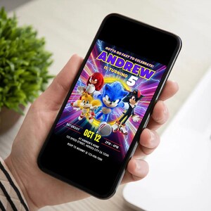 May include: A smartphone displays a colorful birthday invitation featuring Sonic the Hedgehog and friends. The invitation reads "Andrew is turning 5" with event details: Saturday, Oct 12, 2 PM-4 PM, at 123 Speed Street, Heroes City, CA. RSVP to Mommy.