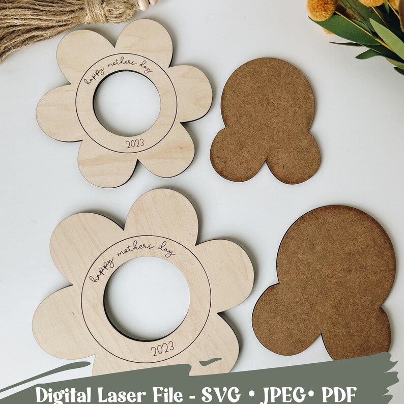 May include: Two unfinished wooden flower-shaped cutouts with a circle in the center. The circle has the text "happy mothers day" and "2023" inscribed. Two additional unfinished wooden cutouts are included, one shaped like a flower and the other shaped like a three-leaf clover.