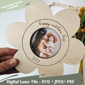 May include: A wooden flower-shaped picture frame with a circular cutout for a photo. The frame is engraved with the text "happy mothers day" and the year "2023".