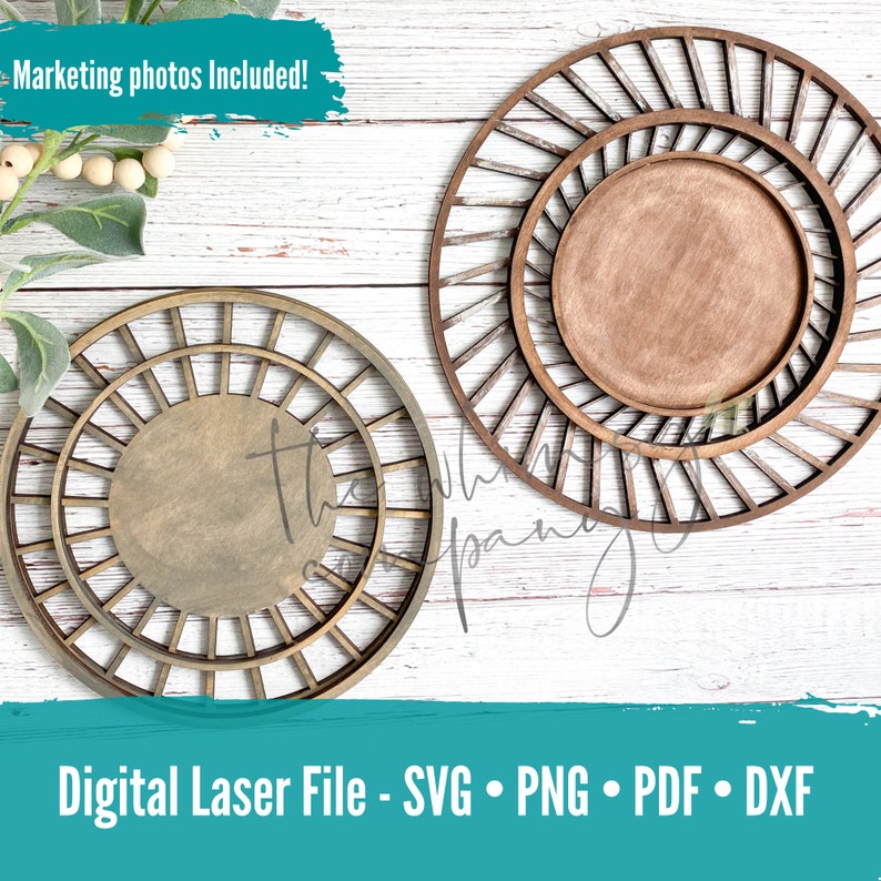 May include: Three wooden laser cut circles with a sunburst design. The circles are different sizes and are arranged in a staggered pattern. The circles are on a white wooden background.