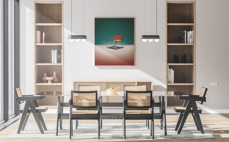 May include: A dining room with a glass table and six chairs. The chairs are black with woven cane seats. There are two bookshelves on either side of the room, and a framed print of a red, yellow, and blue chair on a teal background hangs on the wall above the table.