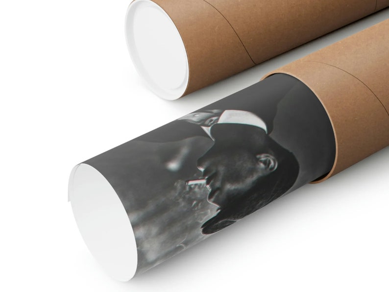 May include: A black and white photograph of a person smoking a cigarette. The photograph is rolled up and inside a brown cardboard tube.