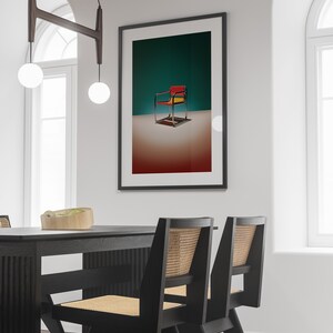 May include: A black framed picture with a colorful chair on a teal background. The chair is red, yellow, and black. The picture is hanging on a white wall above a black dining table with two black chairs.