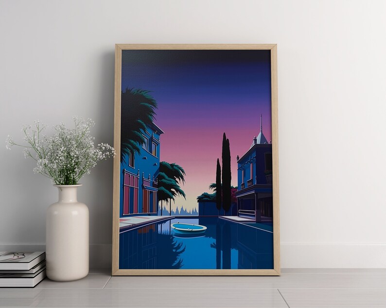 May include: A framed illustration of a blue building with a pool in front of it. The building has a pink door and windows. The pool is surrounded by palm trees and a purple sky.