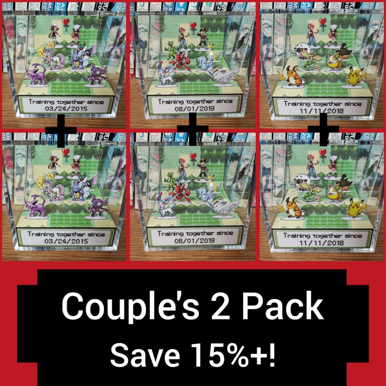 May include: Two sets of Pokemon themed 3D dioramas in clear acrylic boxes. Each set features a couple of Pokemon characters and a heart. The boxes have a green background and a white label with the text "Training together since" and a date. The text "Couple's 2 Pack Save 15%+!" is at the bottom of the image.