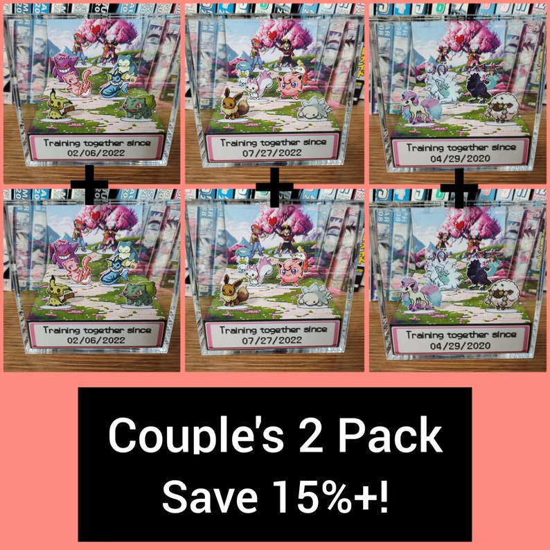 May include: Two clear acrylic boxes with a 3D diorama of Pokemon characters inside. The boxes have a white label with the text "Training together since" and a date. The text "Couple's 2 Pack Save 15%+!" is at the bottom of the image.