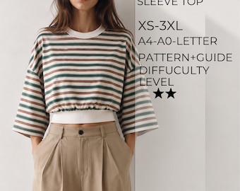 Puede incluir: Una blusa oversize de manga larga con rayas horizontales verdes y marrones, cuello redondo blanco y dobladillo blanco ajustado en la cintura. El texto dice: OVERSIZE LONG SLEEVE TOP, XS-3XL, A4-A0-LETTER, PATTERN+GUIDE, DIFFICULTY LEVEL, dos estrellas.