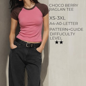 May include: A short-sleeve raglan tee with a pink torso and dark brown sleeves. Text on the right reads: CHOCO BERRY RAGLAN TEE, XS-3XL, A4-A0-LETTER, PATTERN+GUIDE, DIFFICULTY LEVEL, and two star icons representing the sewing project complexity.