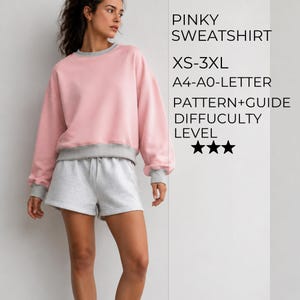 Könnte beinhalten: Ein hellrosa Sweatshirt mit grauem Rundhalsausschnitt, Bündchen und Saum, kombiniert mit grauen Shorts. Der Text lautet: PINKY SWEATSHIRT, XS-3XL, A4-A0-LETTER, PATTERN+GUIDE, DIFFUCULTY LEVEL, sowie drei schwarze Sterne für den Schwierigkeitsgrad.