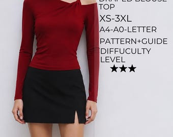 Puede incluir: Una blusa de manga larga de color rojo oscuro con diseño drapeado, escote asimétrico y un tirante. El texto dice: LONG SLEEVE DRAPED BLOUSE TOP, XS-3XL, A4-A0-LETTER, PATTERN+GUIDE, DIFFUCULTY LEVEL, con tres estrellas negras debajo del texto.