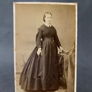 Antique Victorian era portrait photograph of a woman with Victorian hairstyle and full dress with hoop skirt France