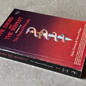 May include: The Sword and the Serpent, Volume 2 of The Magical Philosophy by Melita Denning & Osborne Phillips. The book cover features a colourful illustration of a sword entwined with a serpent.