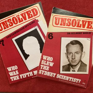 May include: Two red and white magazines with the title "UNSOLVED" in bold red letters. The top magazine is titled "The Cambridge Spy Ring" and features a black and white photo of a person with their face obscured. The bottom magazine is titled "Dr. Gilbert Bogle" and features a black and white photo of a man with a serious expression. The text "Who slew the Sydney Scientist?" is printed in white letters on a red background.