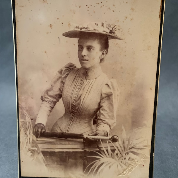 Larger Antique Victorian era photograph studio portrait of woman in corset with hat and parasol 16.4cm x 10.5cm late 1800s early 1900s