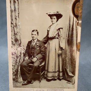 Larger Antique Victorian era photograph studio portrait of well-dressed man and woman 16.5cm x 10.8cm 1900s