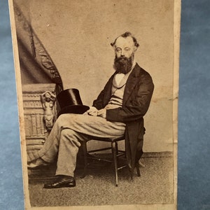 Antique Victorian era portrait photograph of a seated gentleman