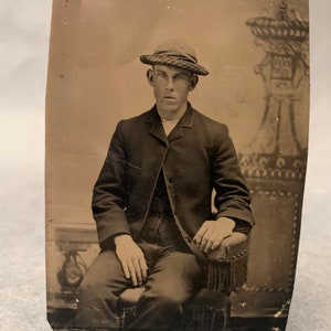 Antique tin type photograph of gentleman in hat studio portrait from around 1900