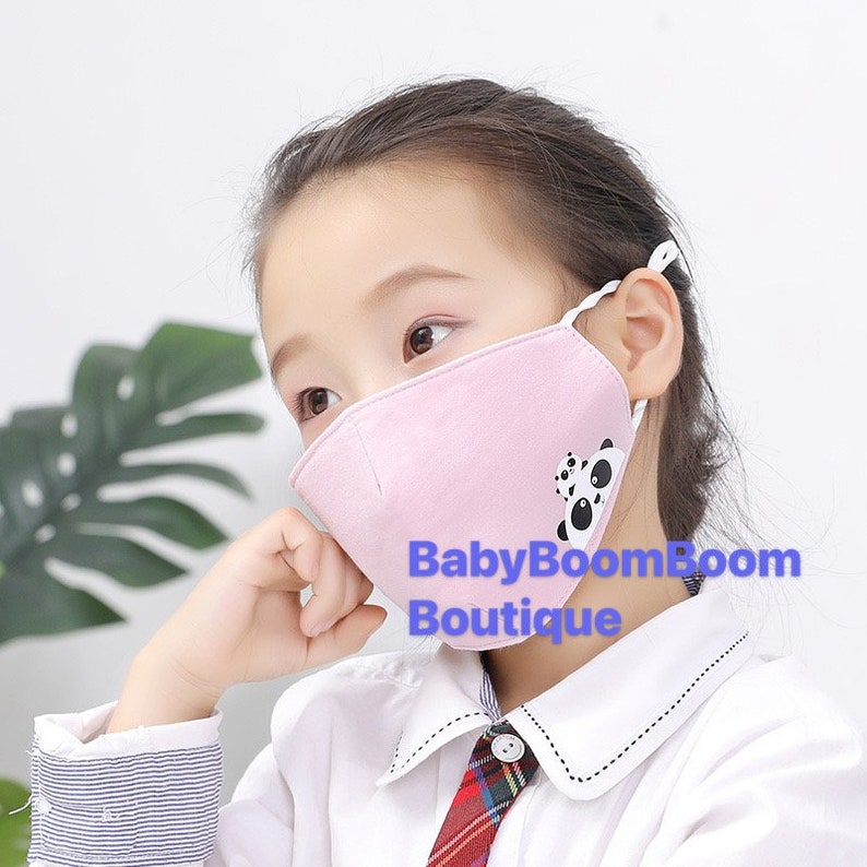 May include: A pink face mask with a panda bear design. The mask has adjustable ear loops and a white border. The text "BabyBoomBoom Boutique" is printed on the mask.