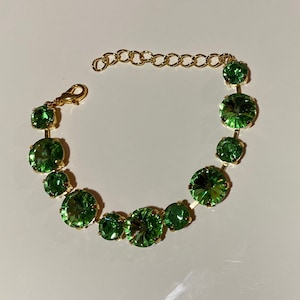Peridot green Swarovski crystal statement tennis bracelet in gold plated setting, Anna Wintour style.
