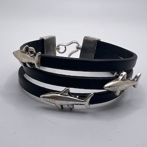 Black leather and silver shark bracelet.