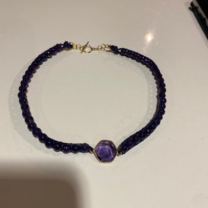 Amethyst and leather choker with gorgeous 14k gold filled bezel set amethyst focal stone. Finished with gold filled toggle clasp.