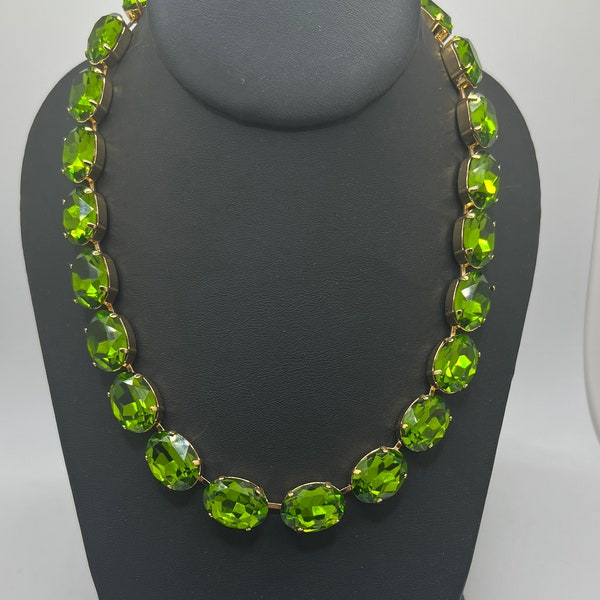 Beautiful Anna Wintour style statement necklace with 18x13 oval fern green crystals in gold plated setting.