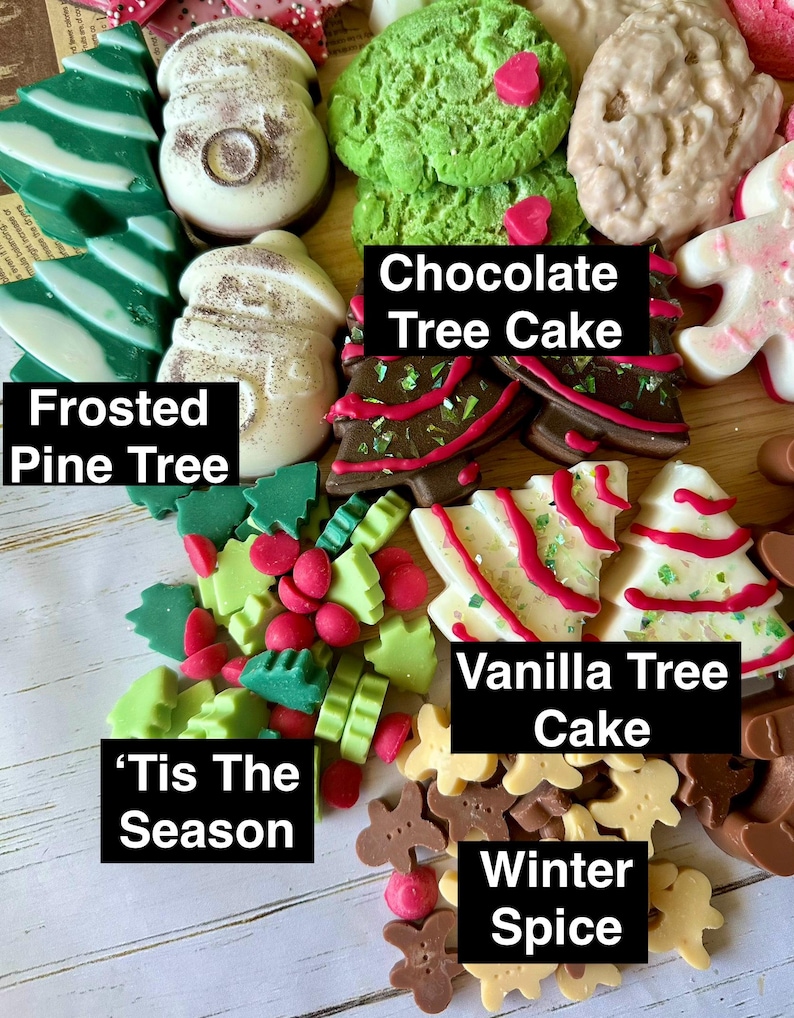 May include: A collection of festive, colorful, and decorative soaps in various shapes. The soaps include frosted pine trees, chocolate tree cakes, and vanilla tree cakes. The text on the image reads "'Tis The Season" and "Winter Spice".