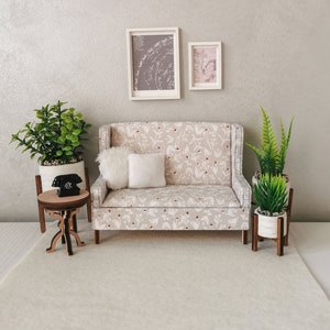 Scale 1/12. Miniature light gray sofa with a print of tiny delicate flowers. A sofa for small dolls. Mini dollhouse sofa.