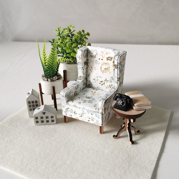 Scale 1/12. Miniature small white armchair with a delicate pattern on the upholstery. Mini dollhouse chair.
