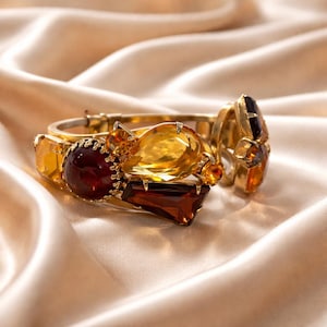 May include: A white ceramic mug with a black handle and the text "But First, Coffee" in a black, bold font. The mug is likely 4 inches tall and holds approximately 12 ounces of liquid.