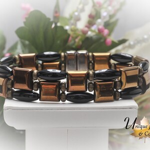 10mm BRONZE PILLOW MAGNETIC with high power 11mm black rice beads with added bronze roundels