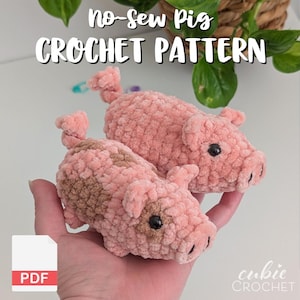 May include: Two plush pig figures made of soft pink yarn with a curly tail, small ears, and black bead eyes. One pig features brown patches. The text reads No-Sew Pig CROCHET PATTERN and PDF. The design is a handmade stuffed animal toy.