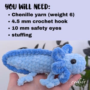 May include: A handmade, light blue crochet axolotl with black safety eyes. The image includes text that reads "YOU WILL NEED: Chenille yarn (weight 6), 4.5 mm crochet hook, 10 mm safety eyes, stuffing." The axolotl is held in a hand.