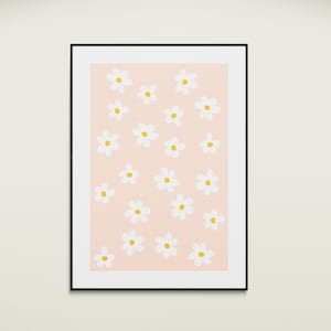 May include: A framed print with a pink background and a pattern of white daisies with yellow centers.