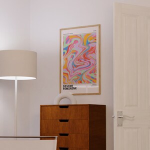 May include: A framed abstract art print with a colorful swirl pattern in shades of pink, blue, yellow, green, and orange. The print is titled "DIVINE FEMININE" and is part of the "Psychedelic Series".