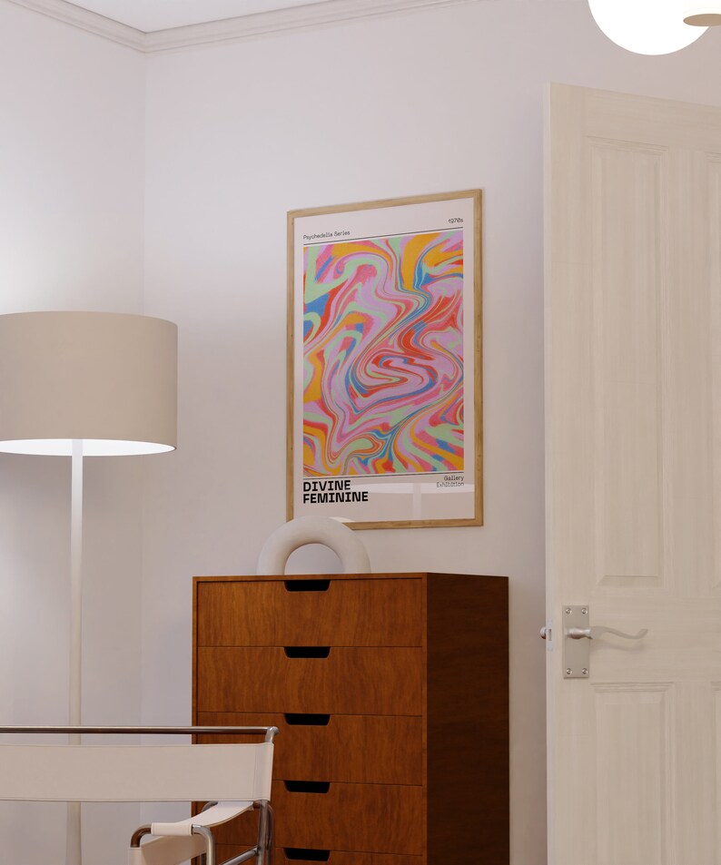 May include: A framed abstract art print with a colorful swirl pattern in shades of pink, blue, yellow, green, and orange. The print is titled "DIVINE FEMININE" and is part of the "Psychedelic Series".