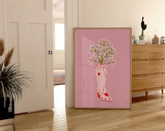 May include: A pink cowboy boot with white flowers growing out of the top, on a pink background.