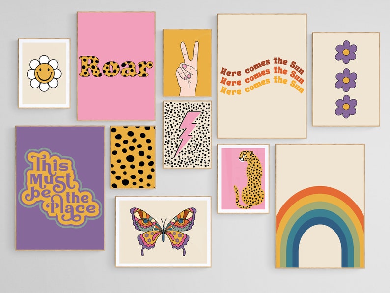 May include: A set of nine colorful wall prints with various designs, including a rainbow, a cheetah, a butterfly, a lightning bolt, a peace sign, a daisy, a flower, and text that says "Roar" and "This Must Be The Place".