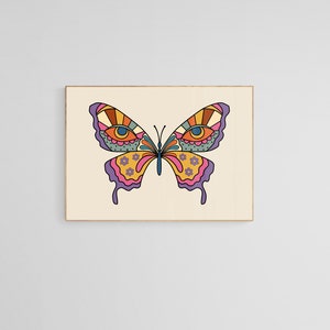 May include: A colorful butterfly with large eyes and intricate patterns on its wings. The butterfly is a vibrant mix of pink, yellow, orange, and blue.