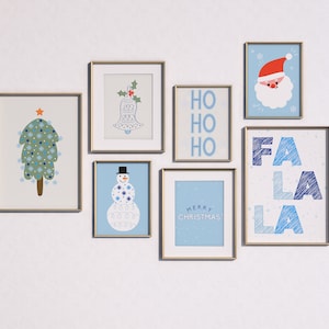 May include: A collection of framed prints with a winter holiday theme. The prints feature a Christmas tree, a snowman, a bell, the words "Ho Ho Ho", and the words "Fa La La La".