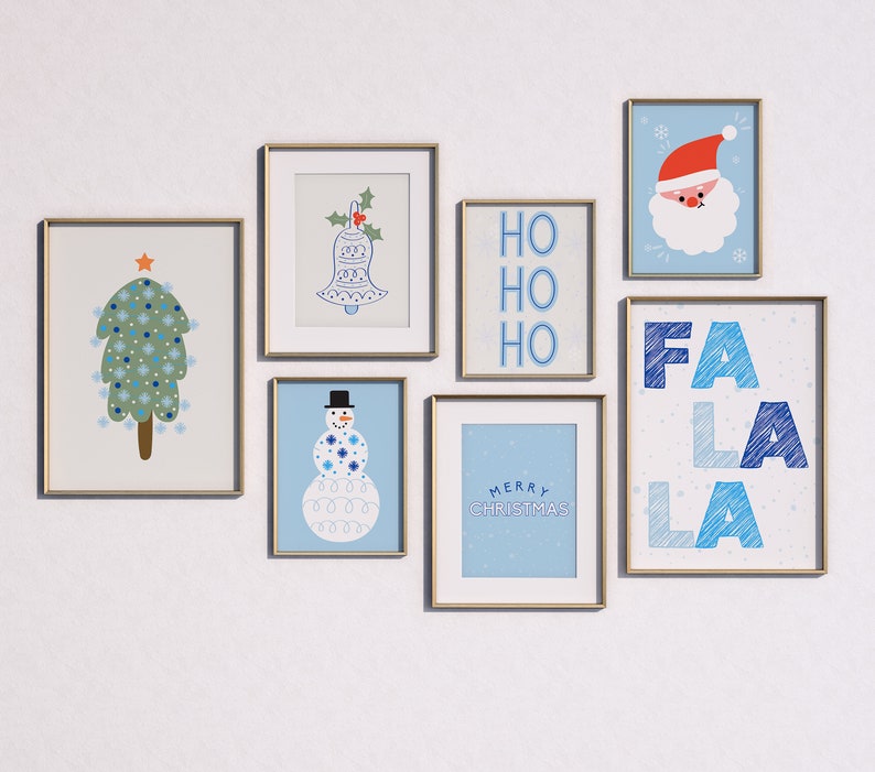May include: A collection of framed prints with a winter holiday theme. The prints feature a Christmas tree, a snowman, a bell, the words "Ho Ho Ho", and the words "Fa La La La".