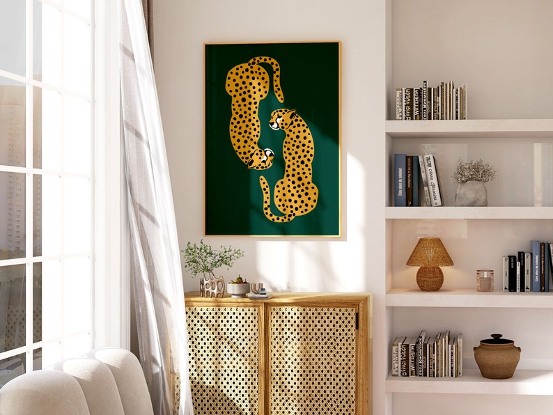 May include: A framed print of two stylized cheetahs in gold and black against a dark green background. The cheetahs are facing each other and appear to be in a playful pose.