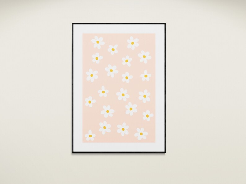 May include: A framed print with a pink background and a pattern of white daisies with yellow centers.