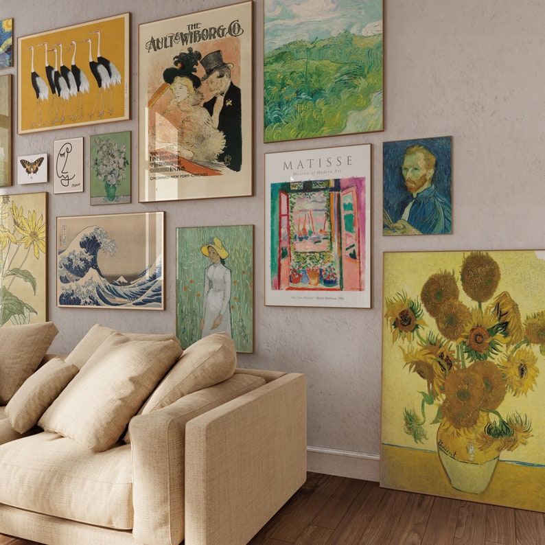 May include: A living room with a beige couch and a wall decorated with framed artwork. The artwork includes a variety of styles, including abstract, impressionistic, and realistic. The artwork features a variety of colors, including blue, green, yellow, and red. The artwork is arranged in a grid pattern on the wall. The couch is facing the wall with the artwork. The couch is made of a soft, beige fabric. The couch has a high back and a wide seat. The couch is comfortable and inviting.