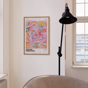 May include: A framed print with a colorful abstract design in shades of pink, blue, green, yellow, and orange. The print is titled "Divine Feminine" and is part of the "Psychedelic Series".