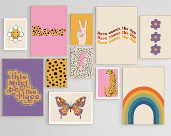 May include: A set of 10 colorful wall art prints with various designs, including a rainbow, a cheetah, a butterfly, a lightning bolt, a peace sign, a daisy, a flower, and text that says "Roar" and "This Must Be The Place".