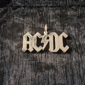 AC DC sterling silver pendant + giftbag and waxcord.