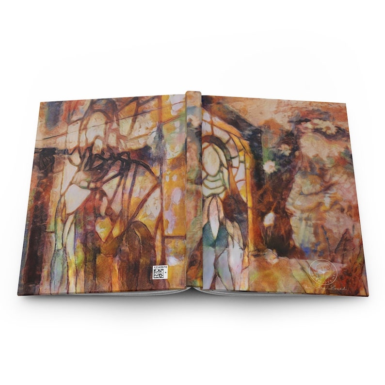 May include: Open journal with a colorful abstract design. The cover features a stained-glass style illustration with warm tones of brown, orange, and yellow. The design includes figures and architectural elements.